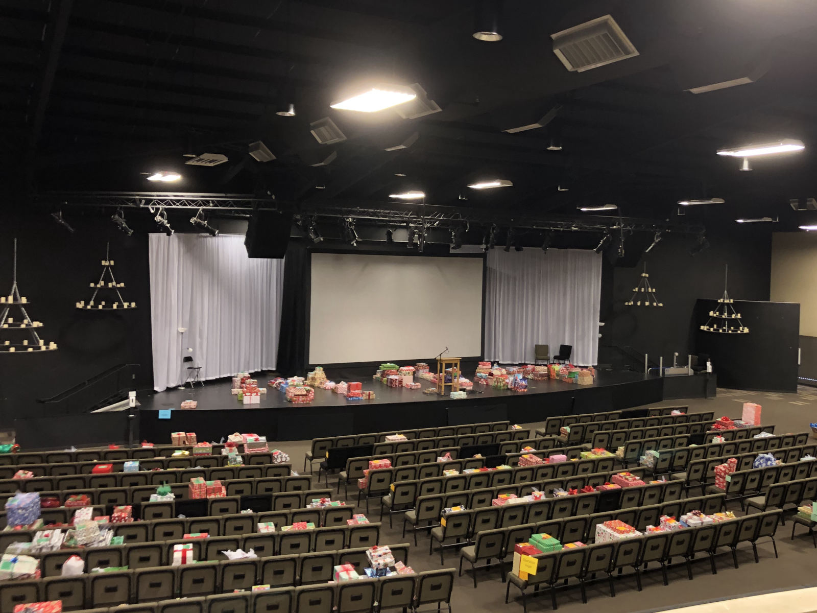 Asbury's sanctuary seen from the balcony, with gifts on the stage and across the rows of chairs